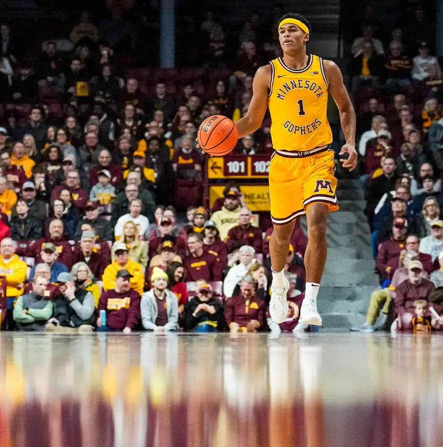 Two basketball players running on the court