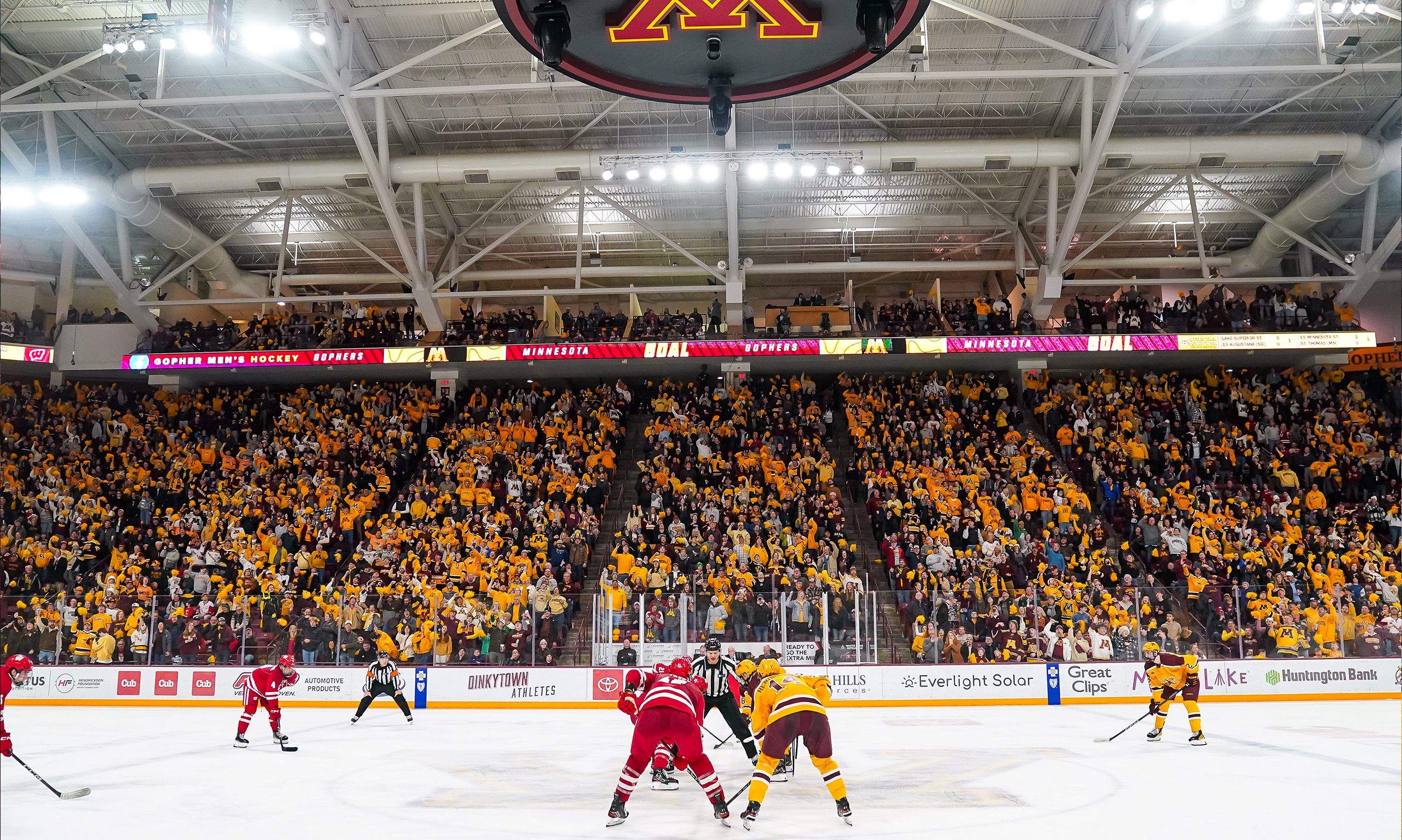 players sitting on bench from behind