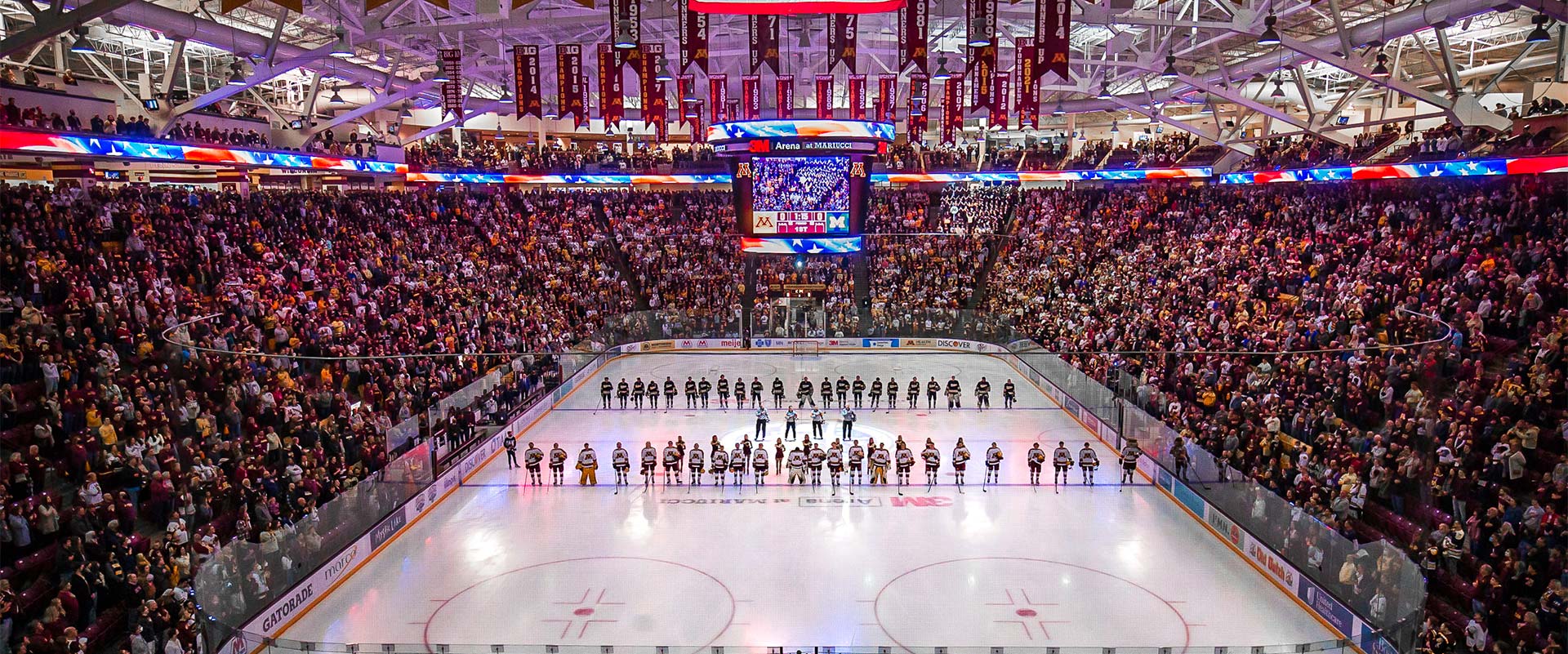 Full arena and players lined up on hockey rink