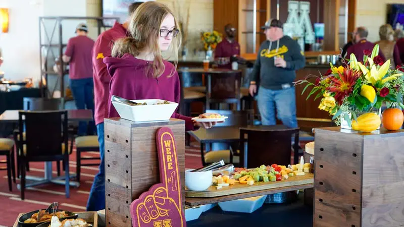 Girl getting food from the table
